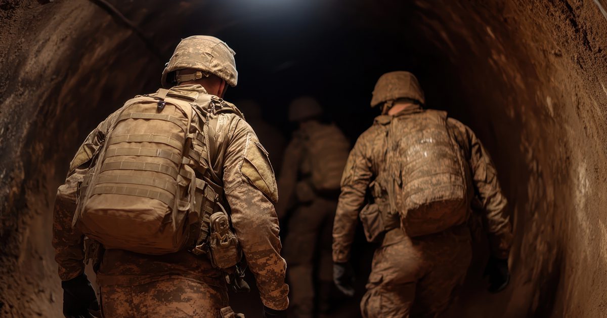 military accessing a dark tunnel