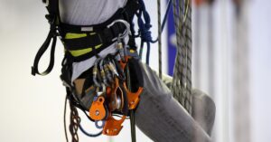 Professional rescue worker wearing a tactical rappel harness